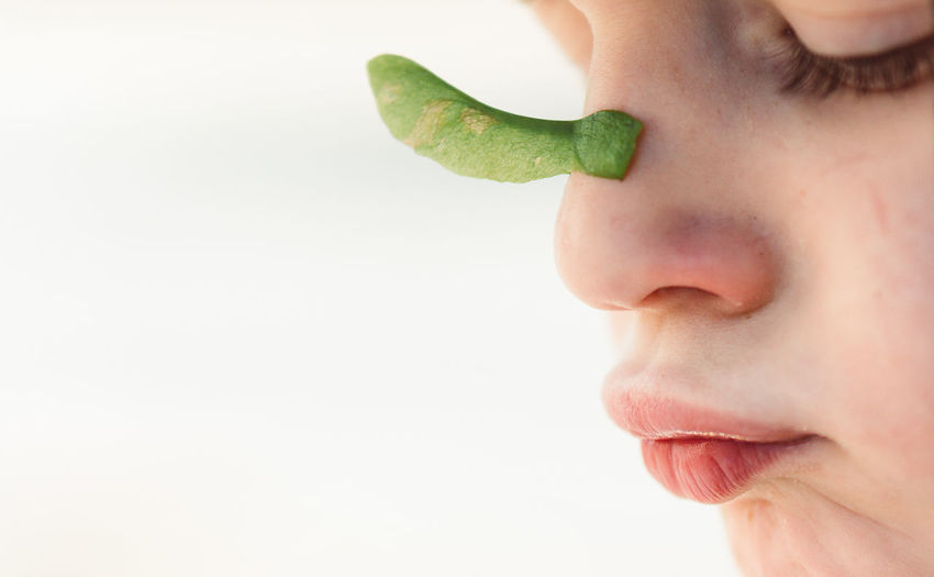 Close-up of child against white background