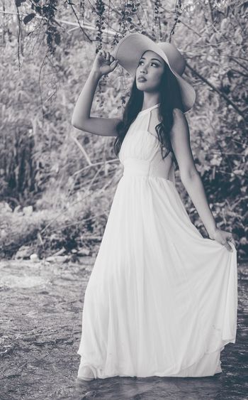 Full length of girl standing by tree