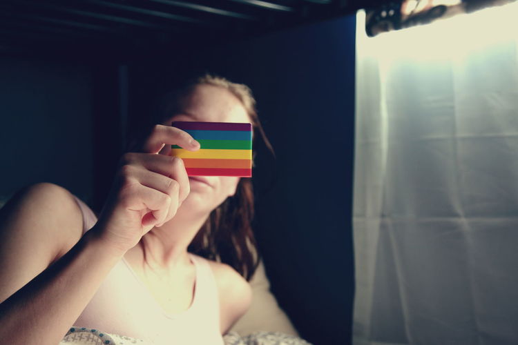 Close-up of girl holding lgbtq flag