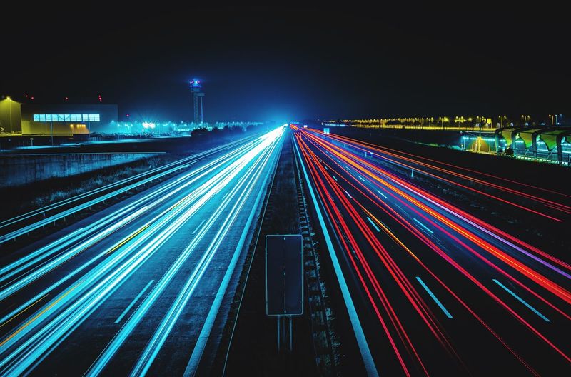 High angle view of light trails on highway at night