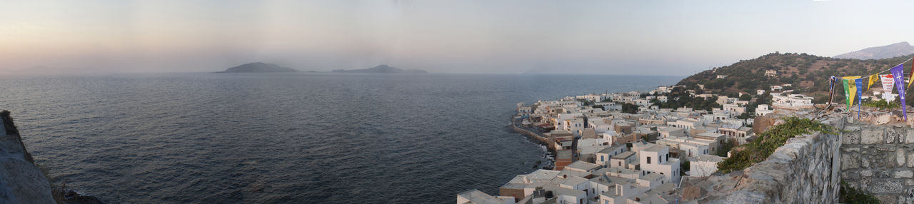 Panoramic view of sea and buildings against sky