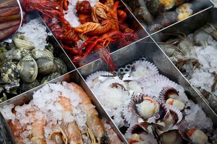 High angle view of seafood in containers at market stall