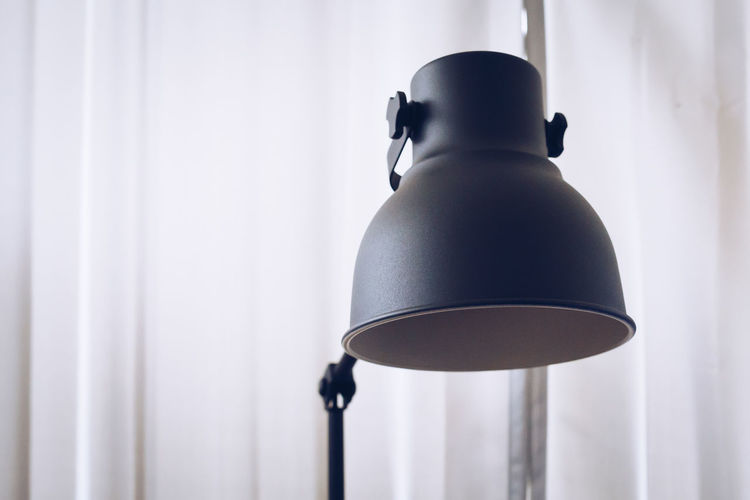 Close-up of desk lamp at home