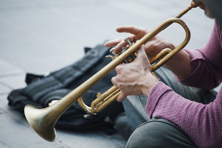 Midsection of man playing trumpet