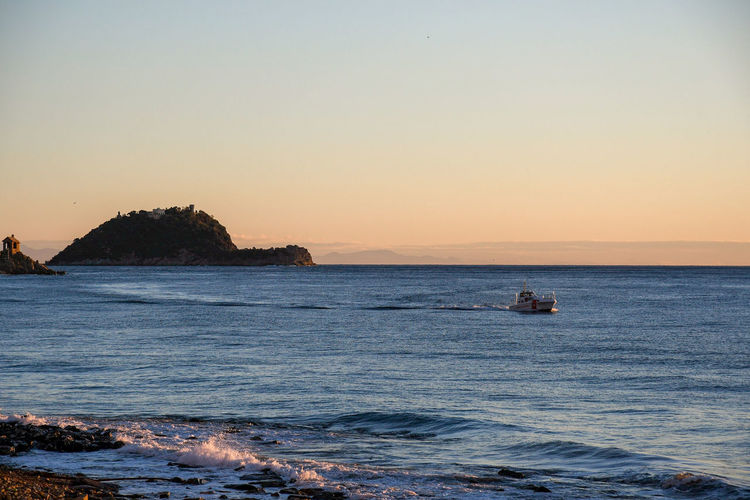 Scenic view of sea against clear sky during sunset