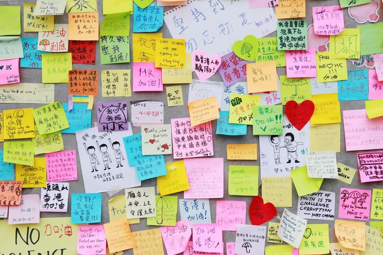 Full frame shot of colorful adhesive notes on wall