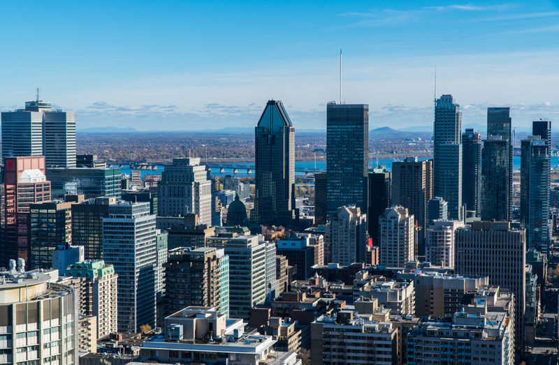 Aerial view of modern buildings in city against sky