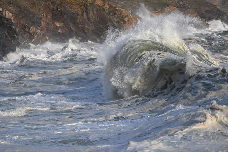 Waves splashing on rocks at sea