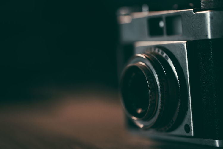 Old vintage camera placed on a blurred background.