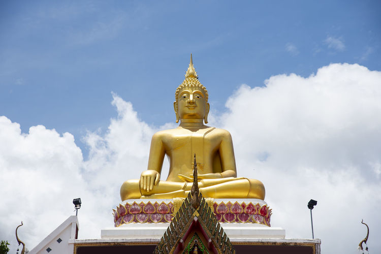 Big buddha on rooftop in nong khai province, thailand. low angle.