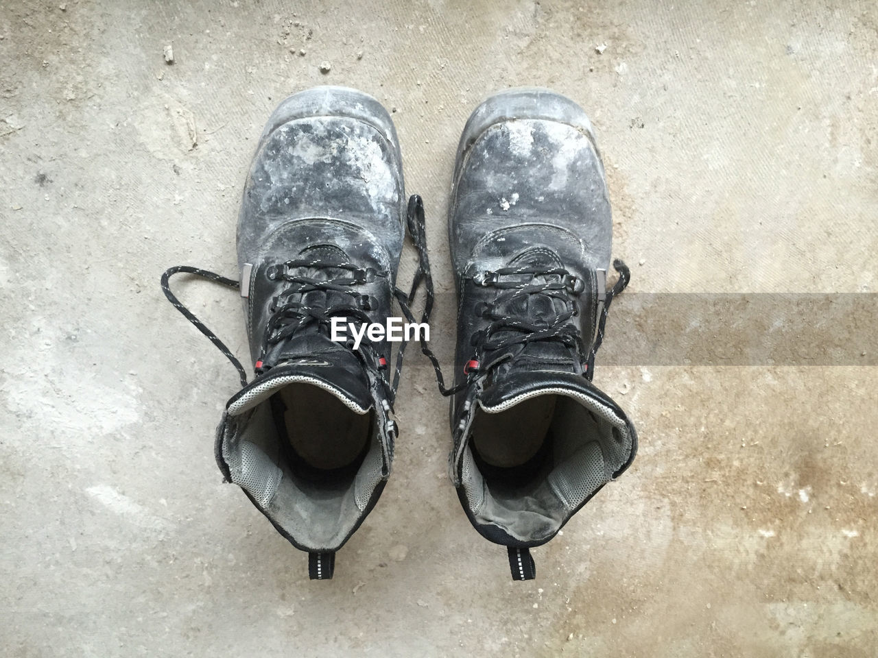 Close-up of dirty shoes on floor