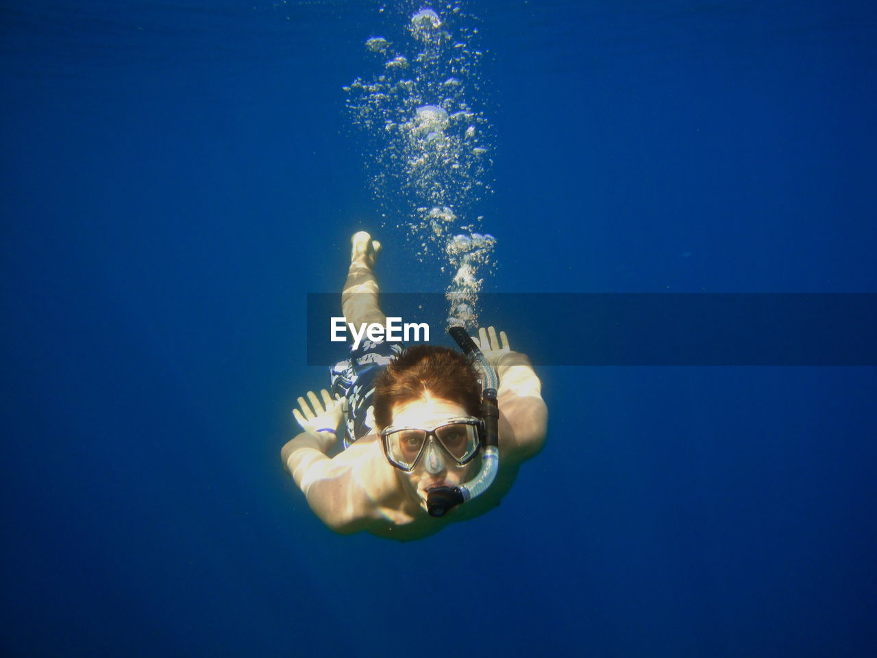Young man looking at camera while snorkeling