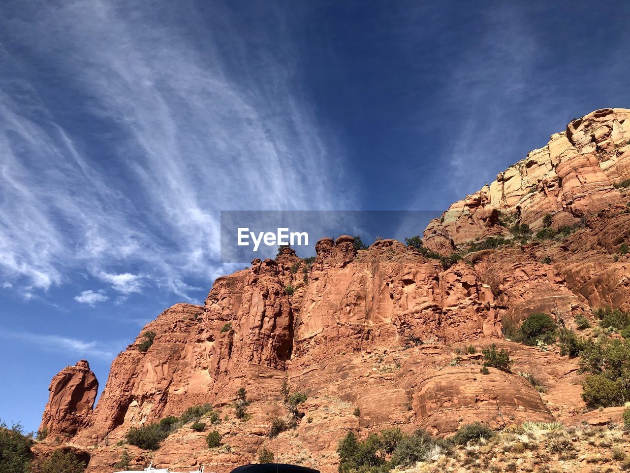 LOW ANGLE VIEW OF ROCK FORMATION IN MOUNTAIN AGAINST SKY