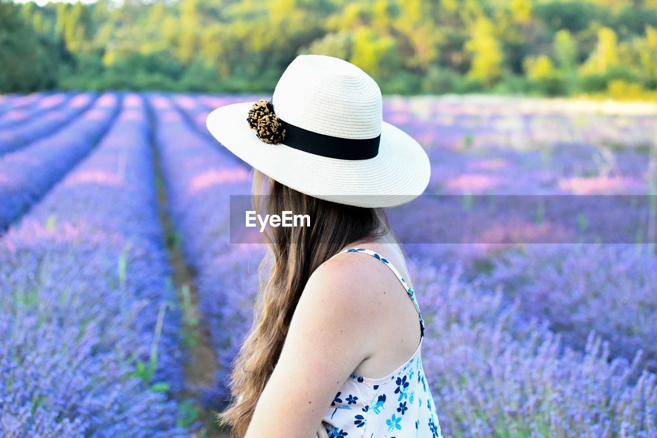 Side view of woman wearing hat at lavender farm