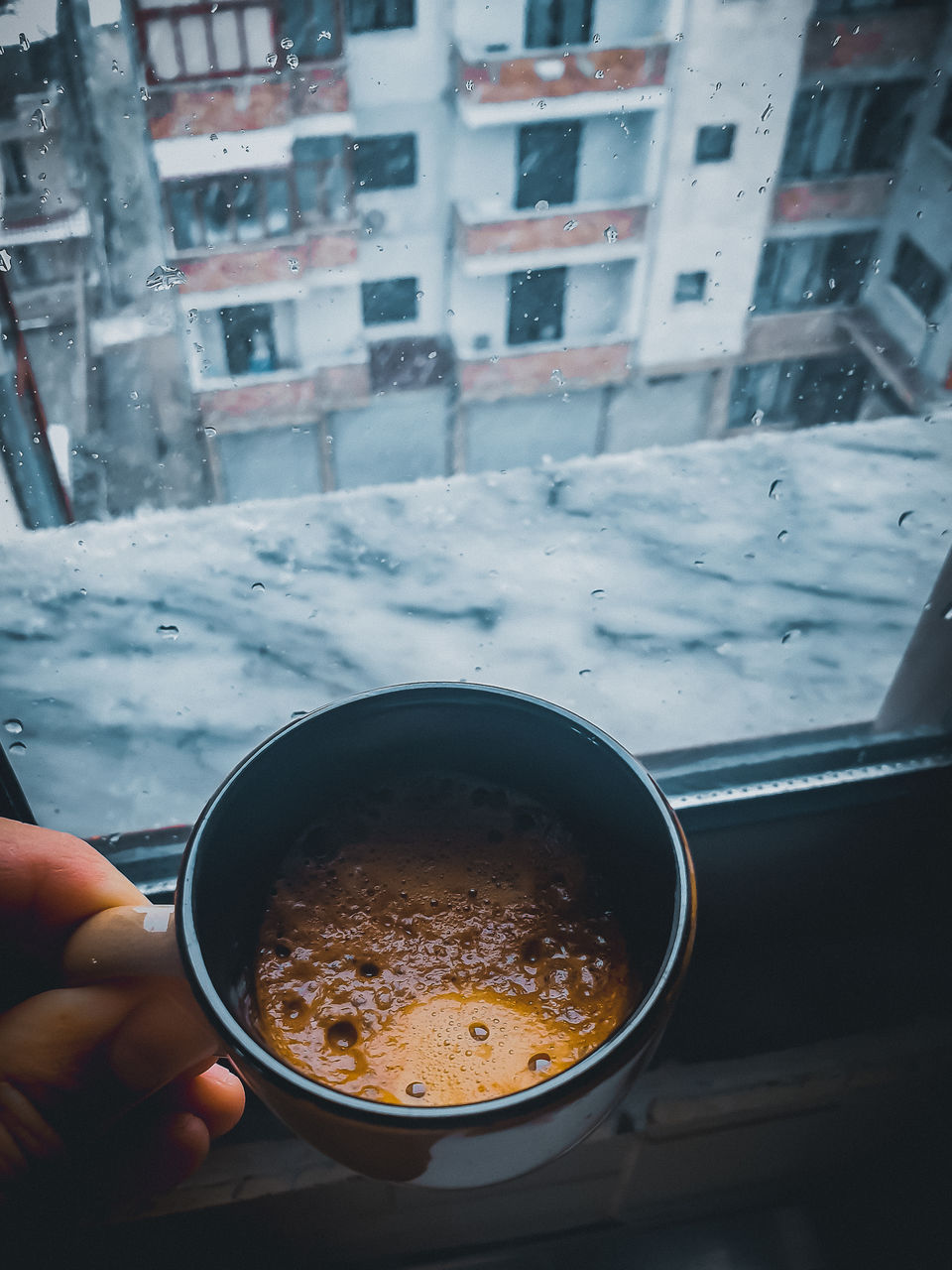 Person holding coffee cup in winter