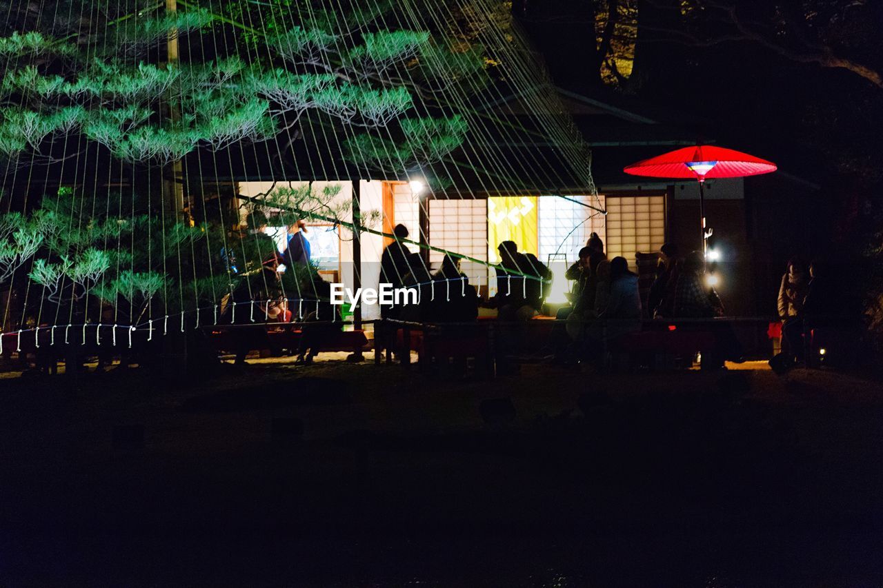 PEOPLE AT ILLUMINATED NIGHT