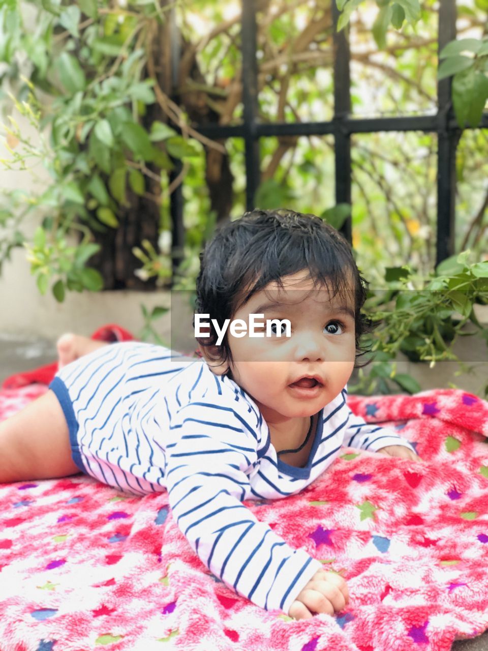 Portrait of cute boy lying outdoors