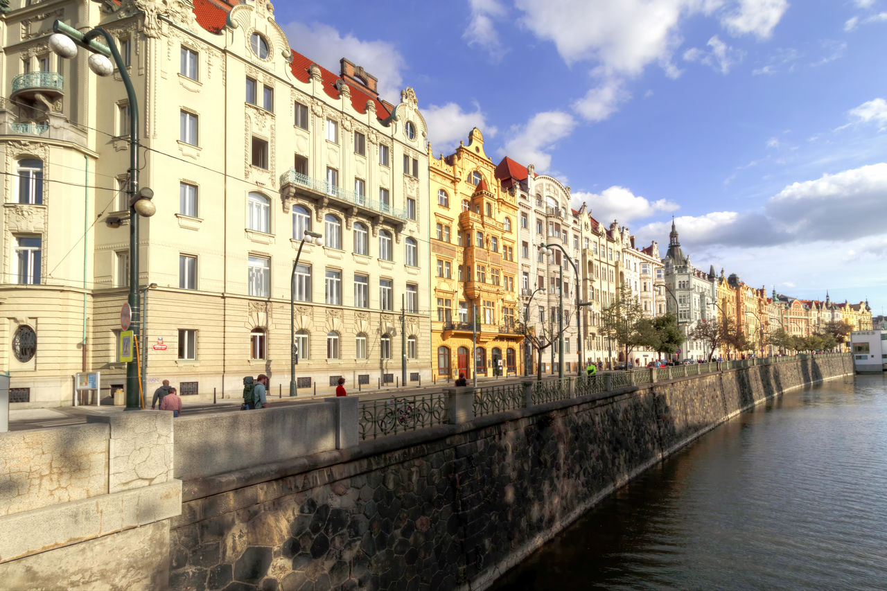 PANORAMIC VIEW OF BUILDINGS BY CANAL AGAINST SKY