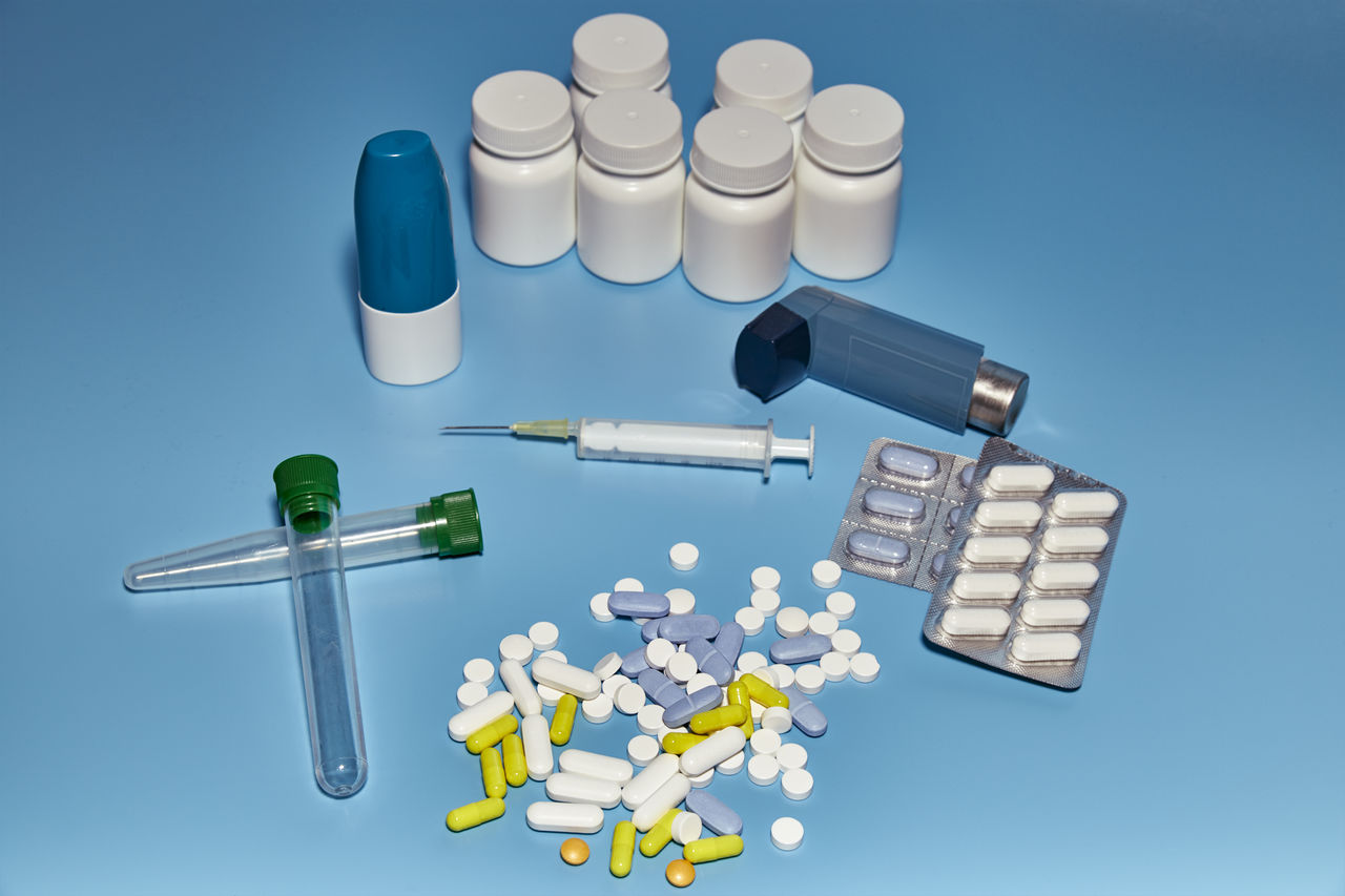 Group of medications varied on a blue background of a pharmacy or a hospital