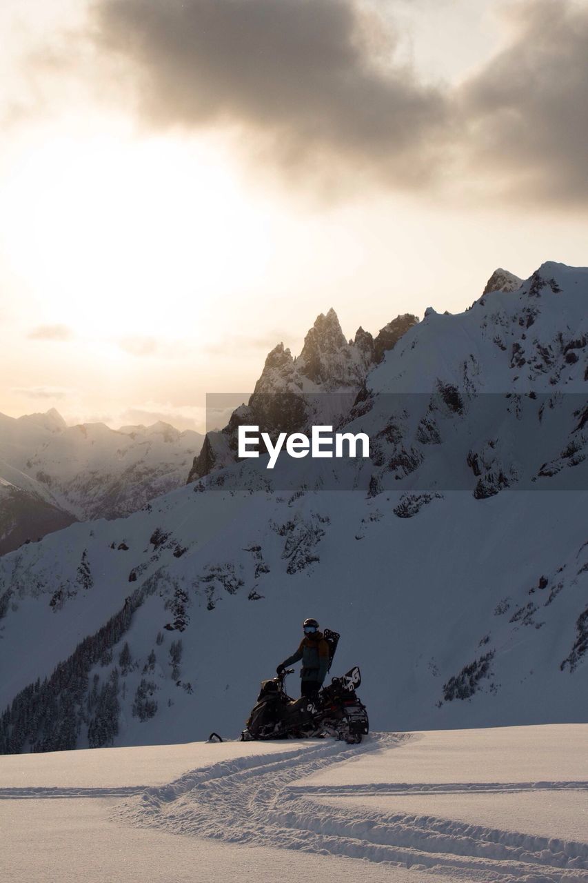 Man snowmobiling on mountain