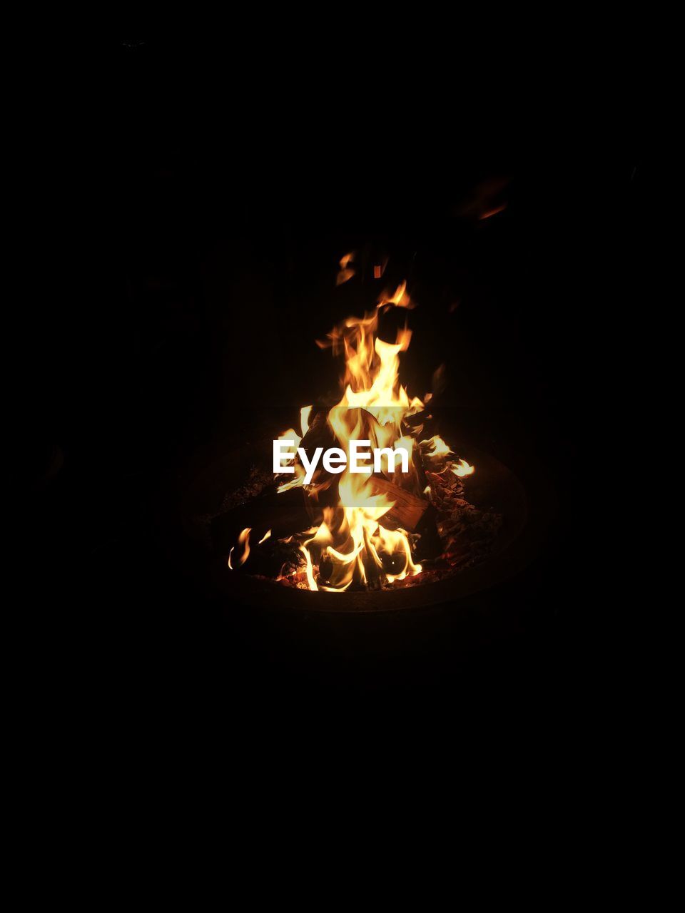 CLOSE-UP OF BONFIRE ON SAND