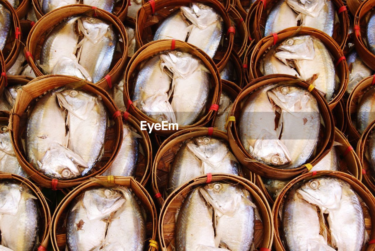 Full frame shot of mackerels in bamboo baskets at market
