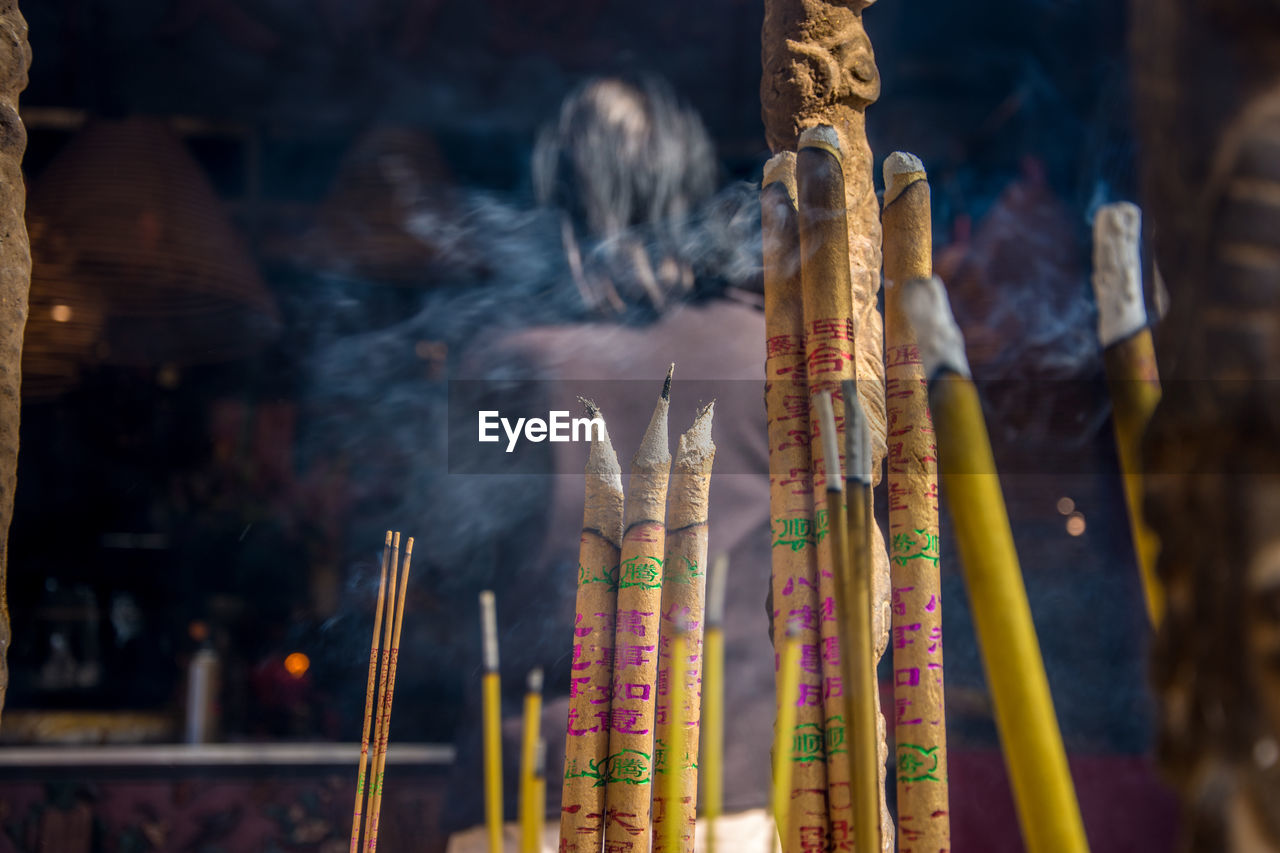 Close-up of incense sticks burning at temple