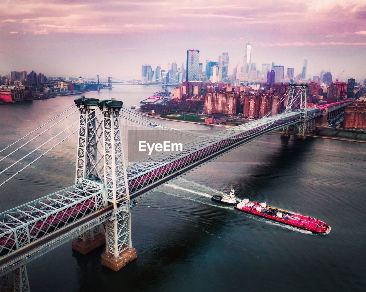 High angle view of bridge over river by buildings in city