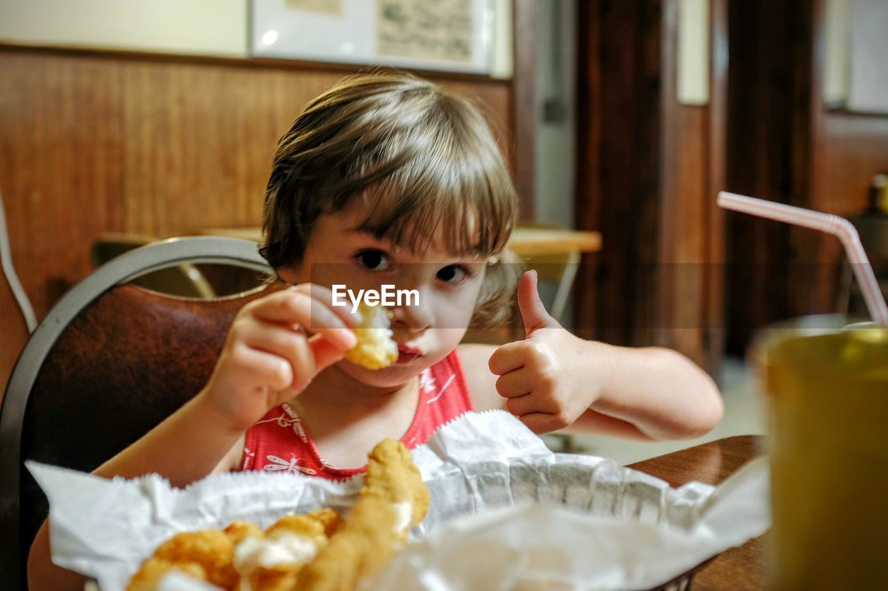 Boy eating in restaurant