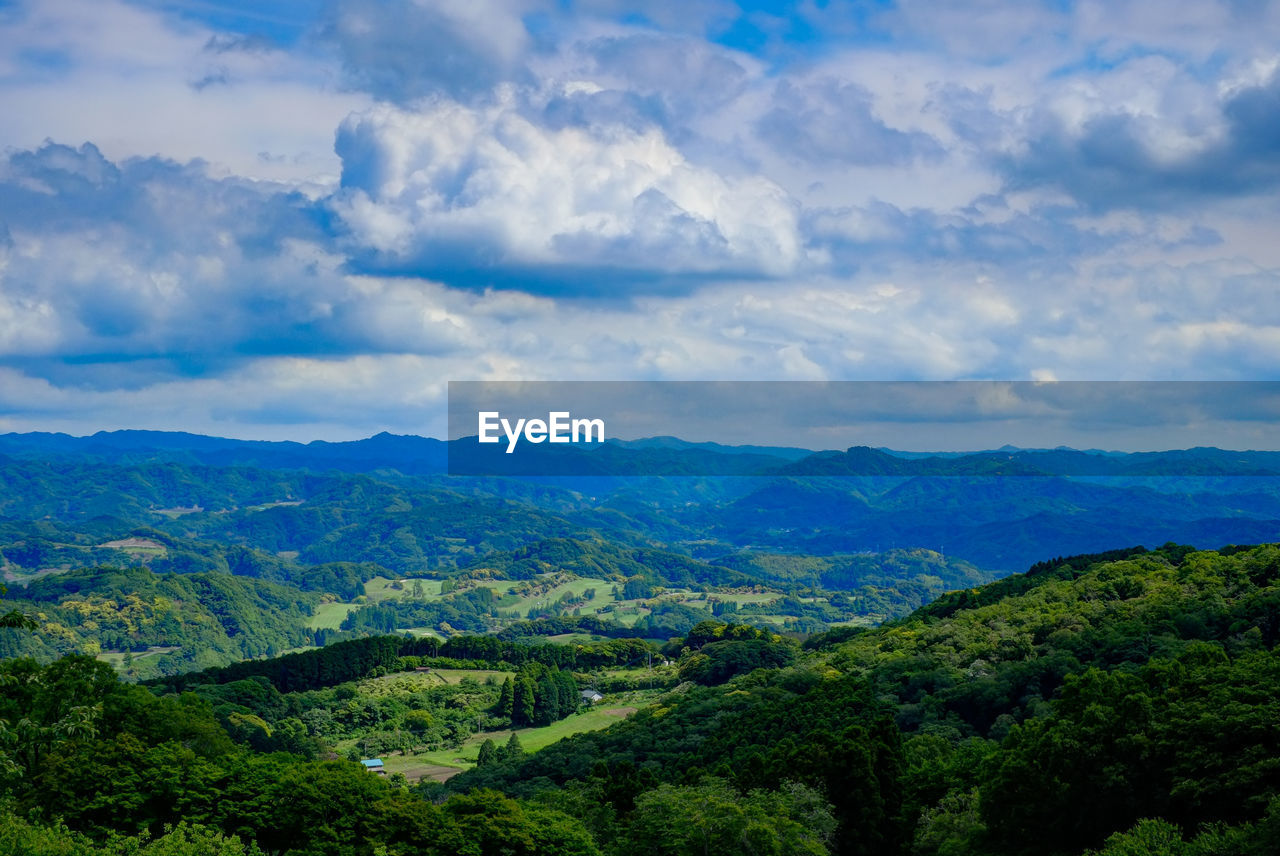 Scenic view of mountains against cloudy sky