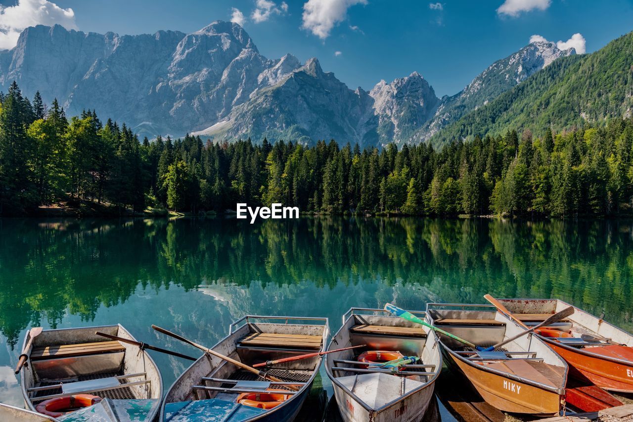 Panoramic view of boats moored in lake against mountains