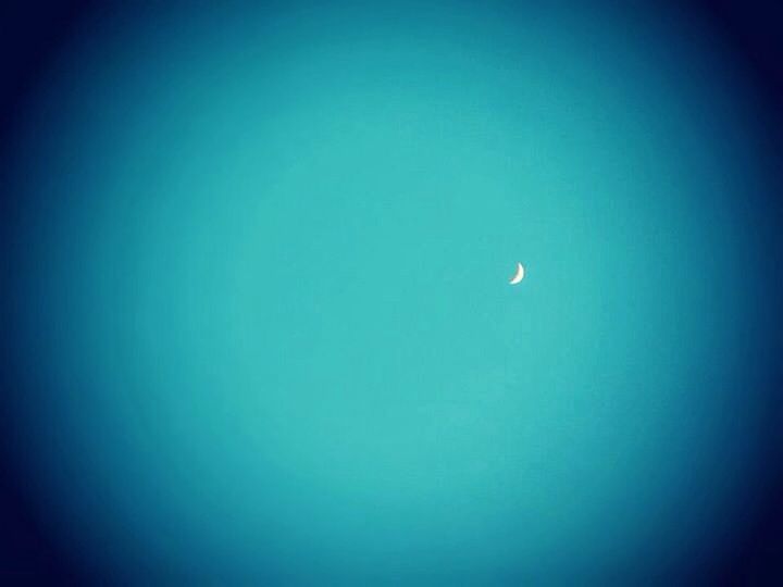 Crescent moon in blue sky