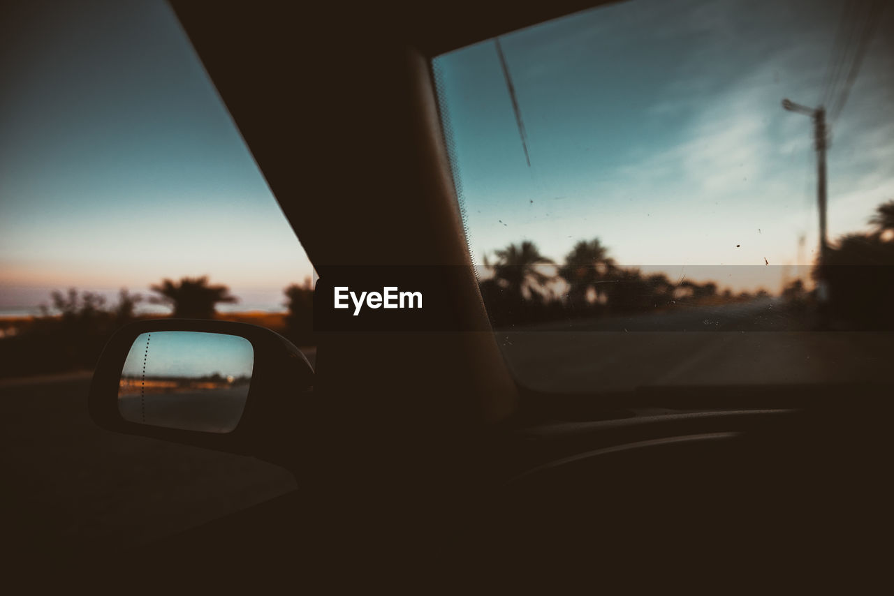 Close-up of car on road against sky