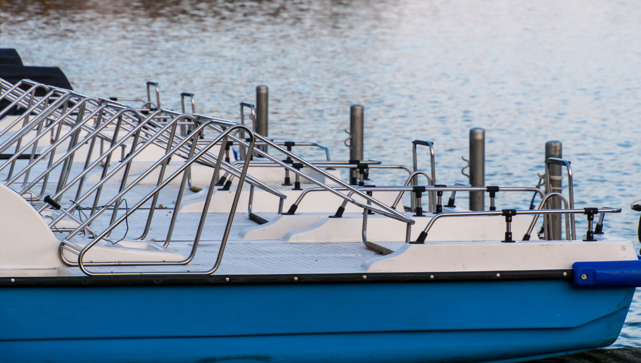 Close-up of pedal boats moored on sea