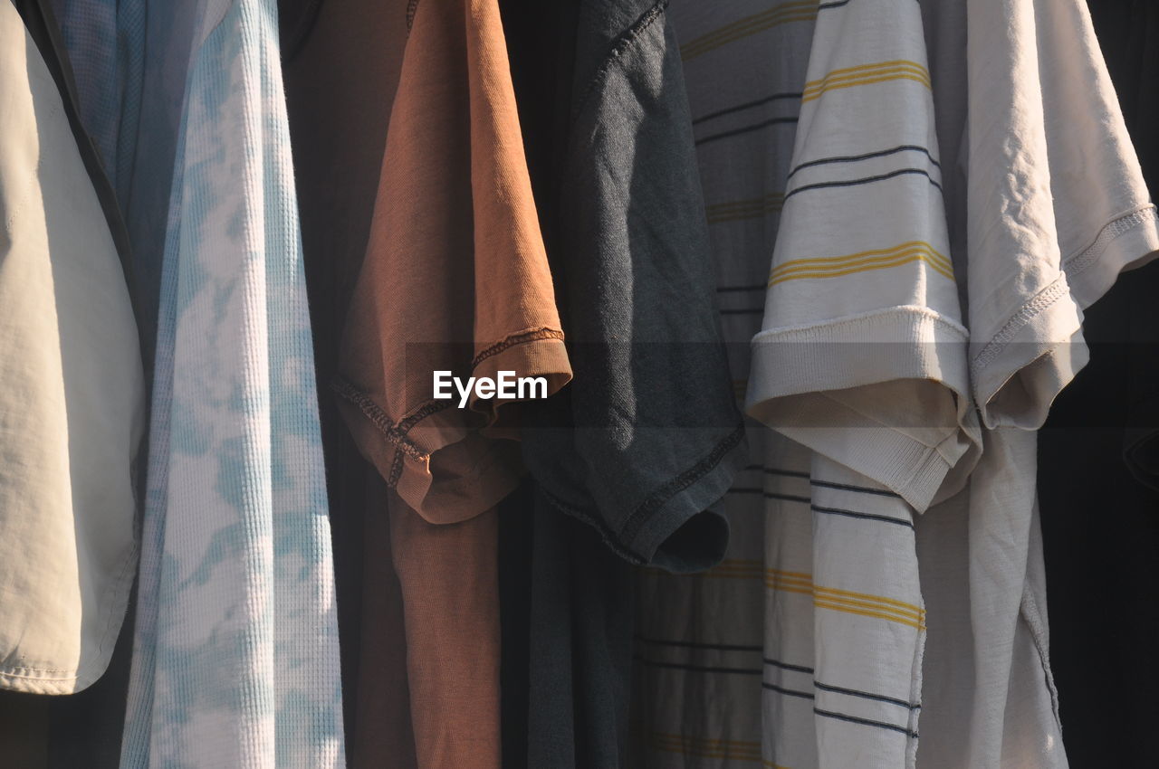 Close-up of clothes hanging on curtain