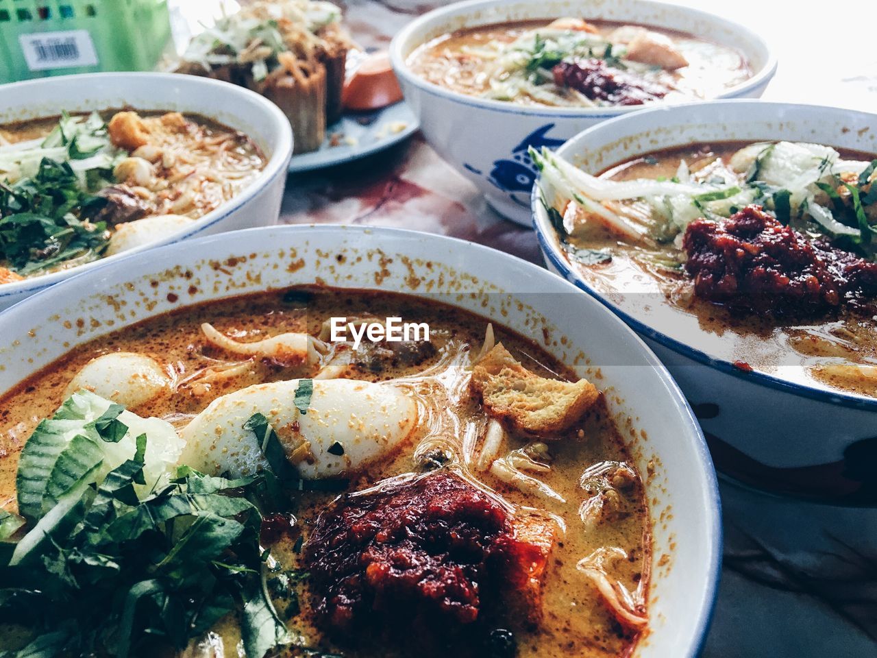 High angle view of laksa served in bowls on table