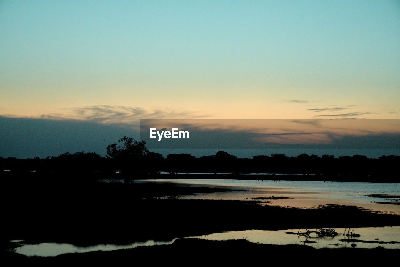 SCENIC VIEW OF SILHOUETTE LANDSCAPE AGAINST SKY DURING SUNSET