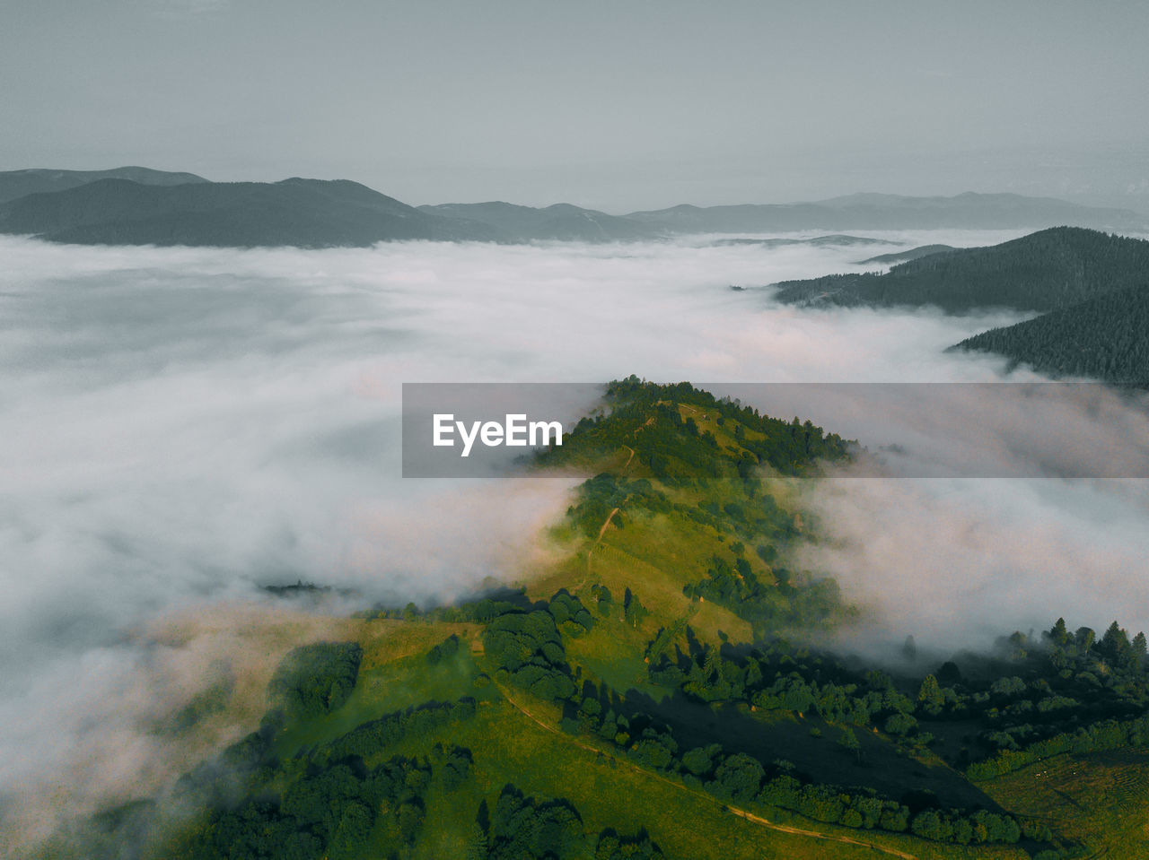 Sea of clouds and picturesque mountains above. beautiful carpathians at early winter or autumn 