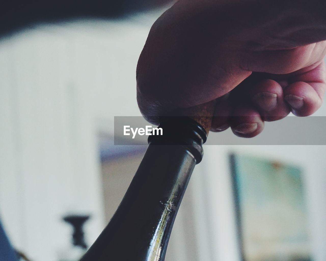 Cropped hand opening wine cork