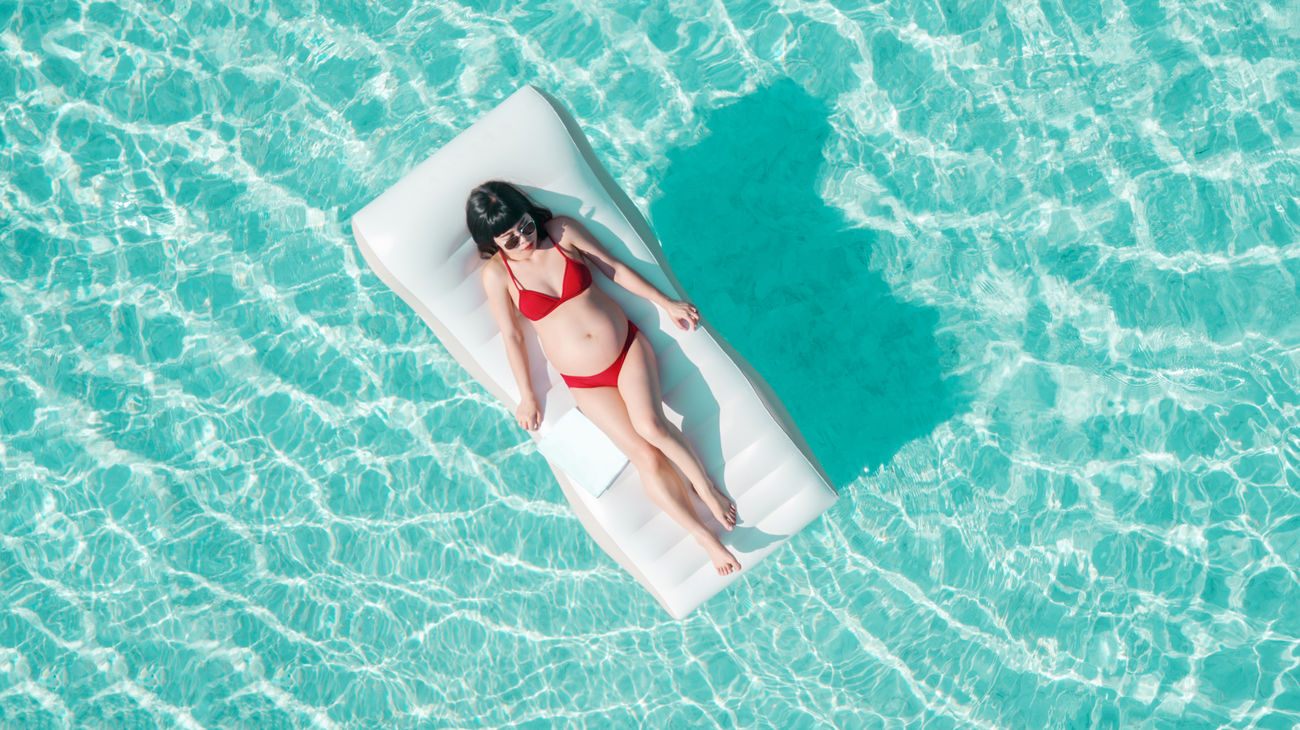 Pregnant Woman Relaxing On Pool Raft In Id 133451519