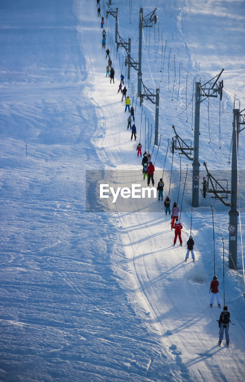 High angle view of people on snow and skilift