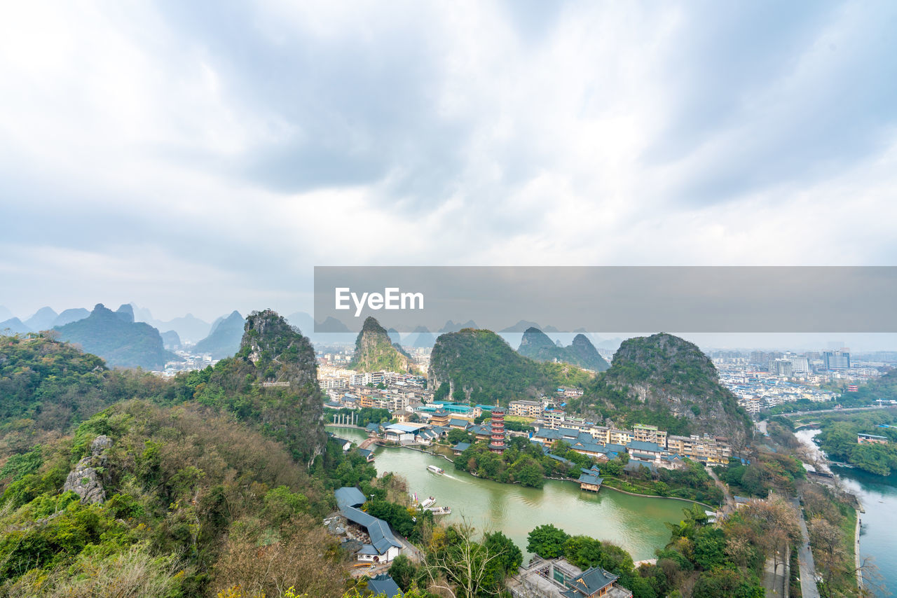 High angle view of river and buildings against sky
