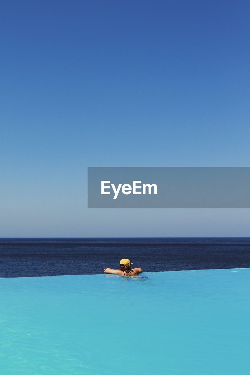 View of swimming pool in sea against clear sky