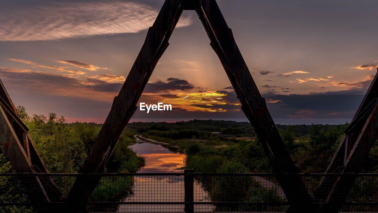 Silhouette bridge against sky during sunset