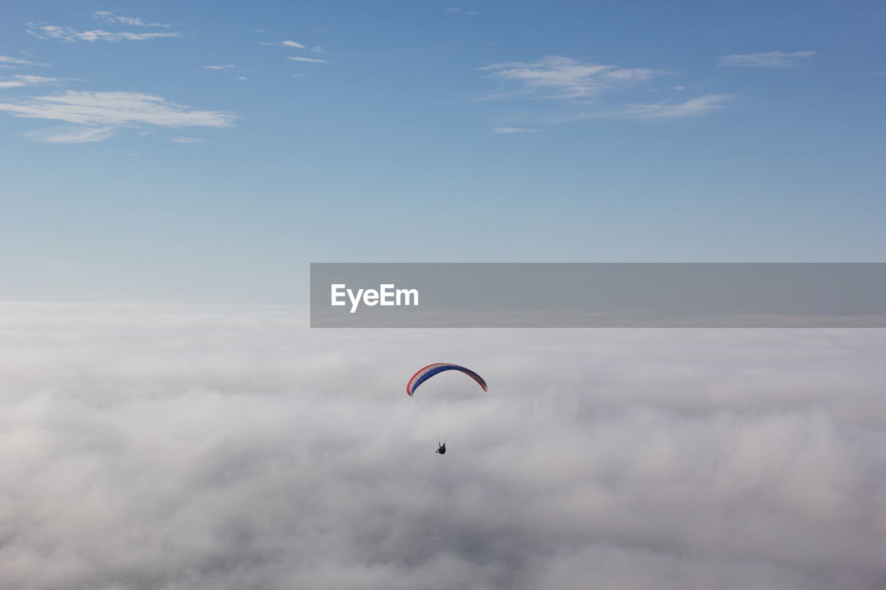 Parachute flying over cloudscape