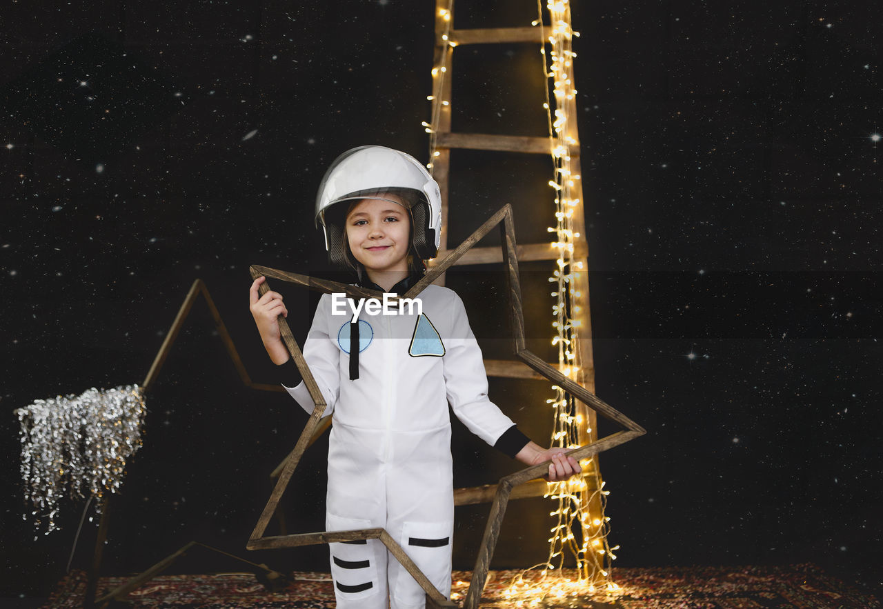 Portrait of smiling girl wearing space suit