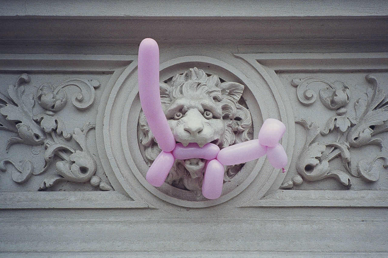 Low angle view of balloon toy on carved wall