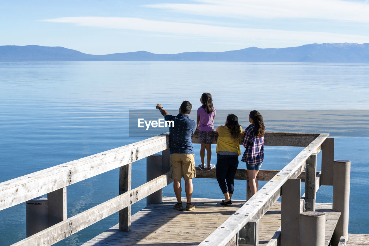 A family on a pier on a beautiful day in south lake tahoe, ca
