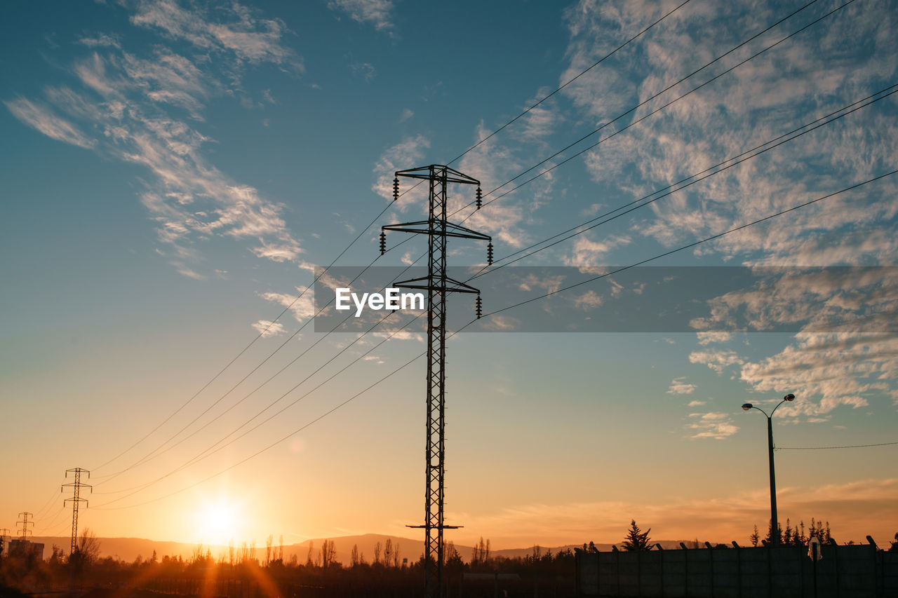 LOW ANGLE VIEW OF SILHOUETTE ELECTRICITY PYLON AGAINST SKY