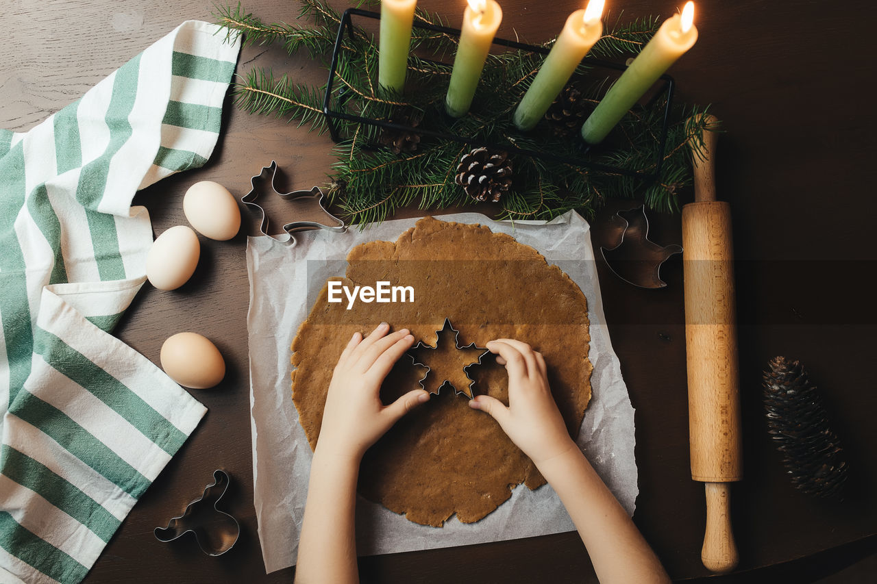 Little girl is baking christmas gingerbread cookies. high quality photo